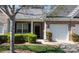 Charming brick townhome featuring a well-manicured lawn, one-car garage, and inviting front entrance at 6222 Meadow Glen Ln, Harrisburg, NC 28075