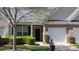 Home exterior featuring brick facade, covered porch, and manicured bushes at 6222 Meadow Glen Ln, Harrisburg, NC 28075