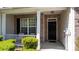 Welcoming front porch featuring a cozy sitting area, brick facade, and well-maintained landscaping at 6222 Meadow Glen Ln, Harrisburg, NC 28075