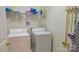 Bright laundry room featuring washer, dryer, and ample shelving at 6222 Meadow Glen Ln, Harrisburg, NC 28075