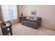 Cozy living room with patterned sofa, decorative painting and a window at 6222 Meadow Glen Ln, Harrisburg, NC 28075