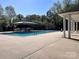 Community pool with ample seating and shaded lounge area for residents at 6222 Meadow Glen Ln, Harrisburg, NC 28075