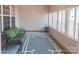 Relaxing sunroom area with a comfortable couch and natural light from multiple windows at 6222 Meadow Glen Ln, Harrisburg, NC 28075