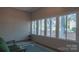 Bright sunroom features large windows with backyard views and comfortable seating at 6222 Meadow Glen Ln, Harrisburg, NC 28075