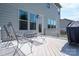 Cozy outdoor deck featuring metal chairs, side table, and views of the backyard at 6352 Willow Farm Dr, Denver, NC 28037