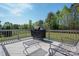 Inviting outdoor deck with grill, seating, and expansive views of lush green landscape at 6352 Willow Farm Dr, Denver, NC 28037