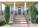 Inviting front entrance with brick steps, black iron railings, and lush landscaping on either side at 6352 Willow Farm Dr, Denver, NC 28037