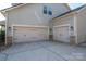 Spacious three-car garage with neutral doors and stone accents, adding curb appeal to the home at 6352 Willow Farm Dr, Denver, NC 28037