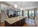 Open concept kitchen with large island overlooking the living room and backyard at 6352 Willow Farm Dr, Denver, NC 28037