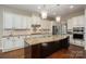 Kitchen featuring a large island with granite countertops and stainless steel appliances at 6352 Willow Farm Dr, Denver, NC 28037