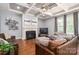 Living room features a fireplace, hardwood floors, large windows, and cozy seating at 6352 Willow Farm Dr, Denver, NC 28037