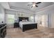 Spacious main bedroom featuring a tray ceiling, a ceiling fan and an ensuite bathroom at 6352 Willow Farm Dr, Denver, NC 28037