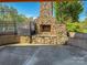 Outdoor fireplace on the patio, made of stone and enclosed with metal fencing at 6352 Willow Farm Dr, Denver, NC 28037