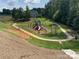View of a nice community playground and walking path surrounded by mature trees at 6352 Willow Farm Dr, Denver, NC 28037