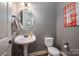 Charming powder room with pedestal sink and decorative mirror at 6352 Willow Farm Dr, Denver, NC 28037