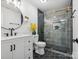 Beautiful bathroom with a tiled shower, black fixtures, and modern vanity with drawers at 6724 Brushwood Dr, Charlotte, NC 28262