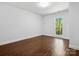 Minimalist bedroom featuring hardwood flooring, natural light, and clean design at 6724 Brushwood Dr, Charlotte, NC 28262