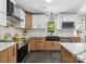 Charming kitchen with white cabinets, black sink, stainless steel appliances, and elegant tile backsplash at 6724 Brushwood Dr, Charlotte, NC 28262