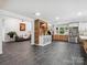 Open-concept living room featuring brick accents, modern decor, and tile flooring throughout at 6724 Brushwood Dr, Charlotte, NC 28262