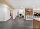 Open-concept living area with modern gray tile, exposed beam, and stylish decorations at 6724 Brushwood Dr, Charlotte, NC 28262