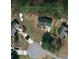 An aerial view shows the property's boundaries within a cul-de-sac neighborhood with mature trees and lush landscaping at 7536 Bimini Ct, Sherrills Ford, NC 28673