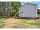 Spacious backyard with green grass, mature trees, and the side of a gray home at 7536 Bimini Ct, Sherrills Ford, NC 28673