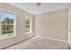 Neutral bedroom with carpet and two windows overlooking the yard at 7536 Bimini Ct, Sherrills Ford, NC 28673