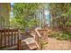 Wooden deck with seating and grill, surrounded by mature trees and greenery at 7536 Bimini Ct, Sherrills Ford, NC 28673