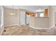 Open dining area with tile flooring and a modern chandelier, adjacent to the kitchen at 7536 Bimini Ct, Sherrills Ford, NC 28673