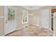 Bright dining area with tile flooring, a modern chandelier, and a glass door to the exterior at 7536 Bimini Ct, Sherrills Ford, NC 28673