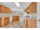 Traditional-style kitchen features wooden cabinetry, neutral countertops and backsplash, and tile flooring at 7536 Bimini Ct, Sherrills Ford, NC 28673