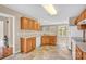 Traditional-style kitchen features wooden cabinetry, neutral countertops and backsplash, and tile flooring at 7536 Bimini Ct, Sherrills Ford, NC 28673