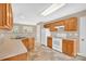 Functional kitchen with tile floor, wood cabinets, and white appliances at 7536 Bimini Ct, Sherrills Ford, NC 28673