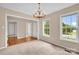 Well-lit living room featuring two windows and neutral walls with wood and carpet flooring at 7536 Bimini Ct, Sherrills Ford, NC 28673