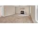 Spacious living room with a cozy fireplace, plush carpet, and neutral paint at 7536 Bimini Ct, Sherrills Ford, NC 28673