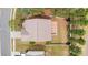 Aerial view of the home, highlighting the roof, backyard patio, and surrounding landscape with lush greenery at 7638 Carrington Forest Ln, Matthews, NC 28105