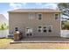 Backyard with a stone patio and outdoor kitchen, and door leading to indoor at 7638 Carrington Forest Ln, Matthews, NC 28105