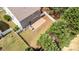 Aerial view of backyard with patio, fence and lush green lawn surrounded by mature trees at 7638 Carrington Forest Ln, Matthews, NC 28105