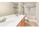 Bright bathroom featuring a double sink vanity and walk-in shower with glass door at 7638 Carrington Forest Ln, Matthews, NC 28105