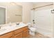 Bathroom features a double sink vanity, toilet, and a shower-tub combo at 7638 Carrington Forest Ln, Matthews, NC 28105