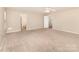 Spacious bedroom featuring neutral carpeting, ample natural light, and ensuite access at 7638 Carrington Forest Ln, Matthews, NC 28105