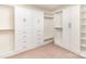 Walk-in closet with custom shelving, drawers, and ample storage space at 7638 Carrington Forest Ln, Matthews, NC 28105