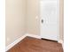Entryway featuring hardwood floors and a white front door at 7638 Carrington Forest Ln, Matthews, NC 28105