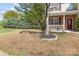 Charming two-story home with landscaped front yard, stone accents, and inviting porch at 7638 Carrington Forest Ln, Matthews, NC 28105