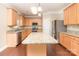 An open kitchen with stainless steel appliances, a central island, and ample cabinet space at 7638 Carrington Forest Ln, Matthews, NC 28105