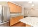 Spacious kitchen with granite countertops, stainless steel refrigerator, and ample wood cabinets at 7638 Carrington Forest Ln, Matthews, NC 28105