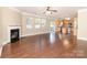 Open-concept living room with fireplace flows seamlessly into the kitchen and dining areas at 7638 Carrington Forest Ln, Matthews, NC 28105
