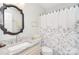 Bright bathroom featuring a marble vanity top and patterned shower curtain at 8257 Legare Ct, Charlotte, NC 28210