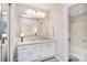 Bright bathroom features a large mirror, white cabinets, and a bathtub with shower at 8257 Legare Ct, Charlotte, NC 28210
