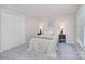 Cozy bedroom with a neutral color scheme, bedside tables with lamps, and a double closet at 8257 Legare Ct, Charlotte, NC 28210